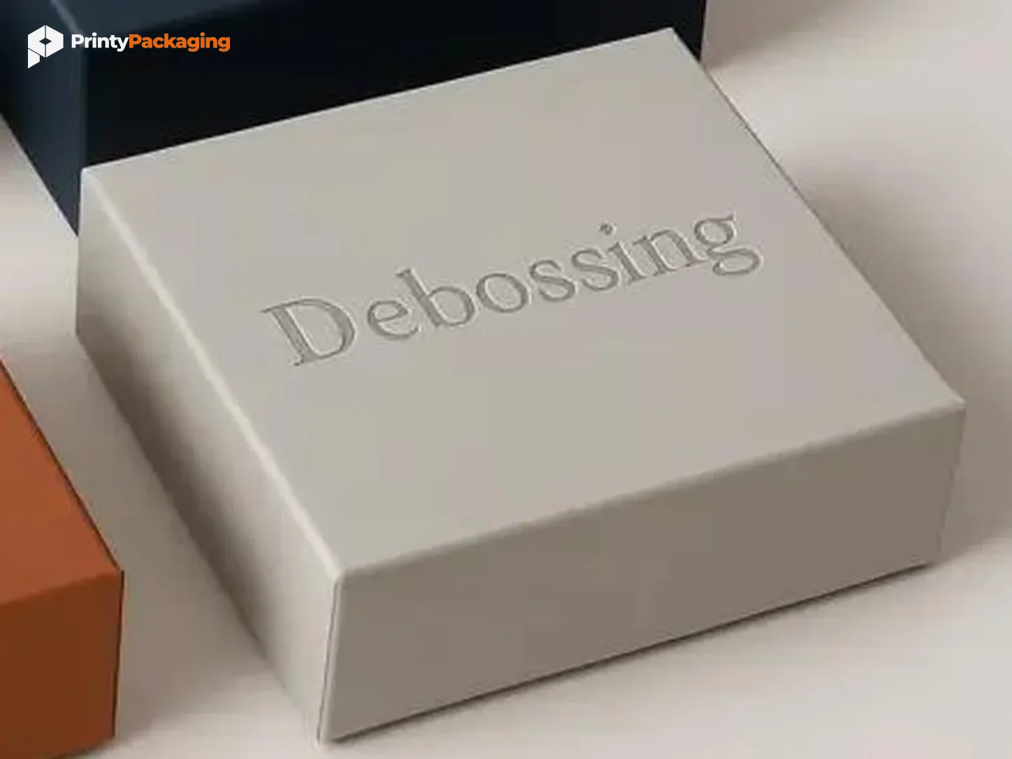 Grey box with debossed lettering pressed into the surface