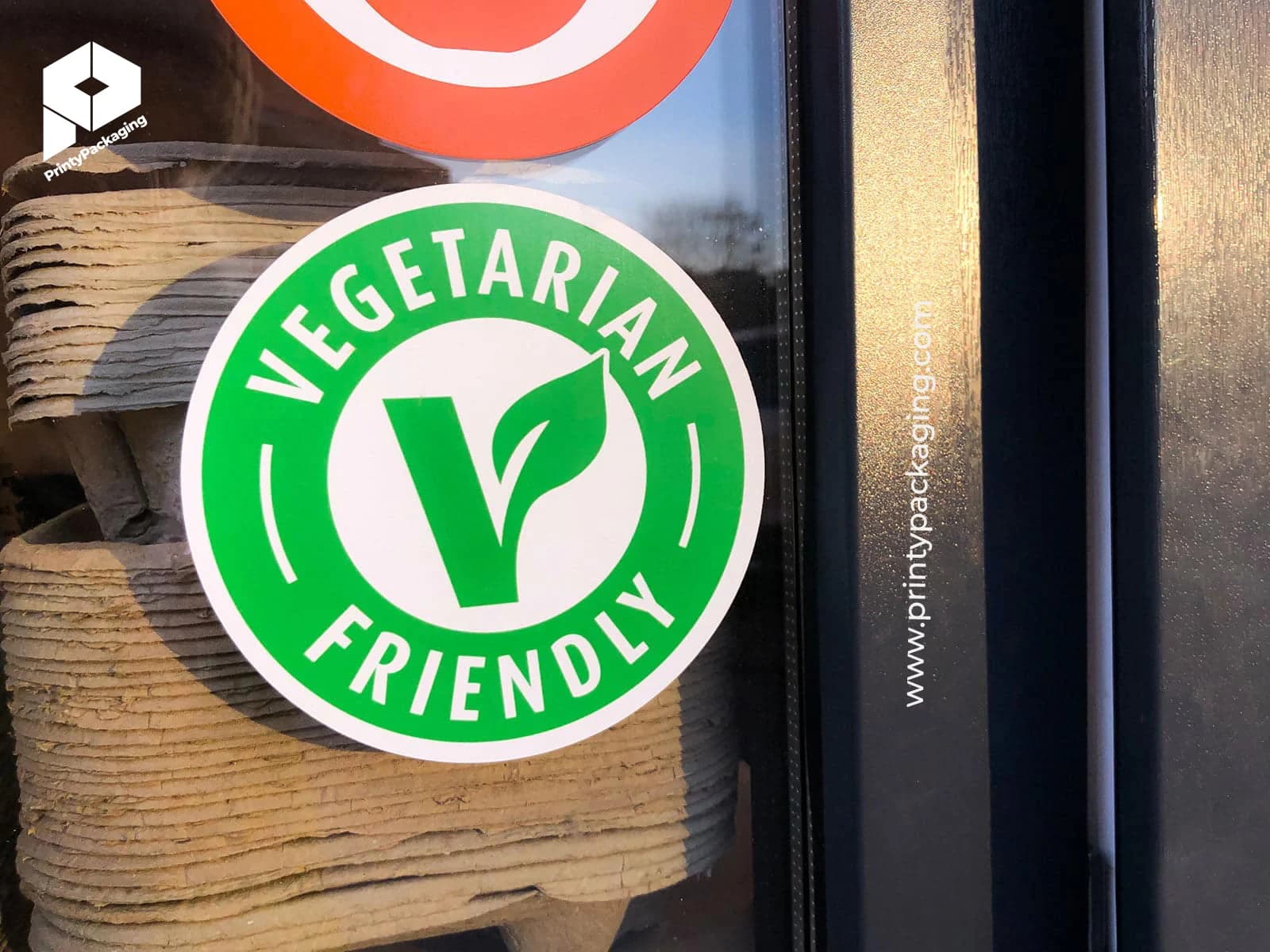 Round vegetarian friendly static cling on a shop window