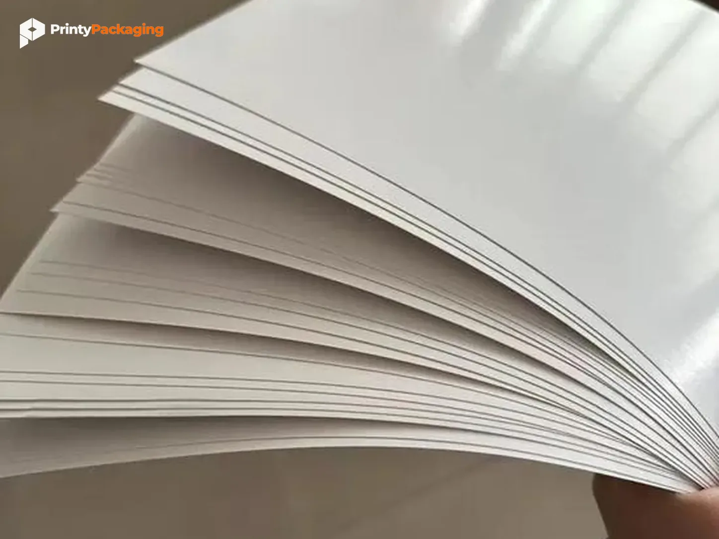 Fanned stack of glossy coated paper stock